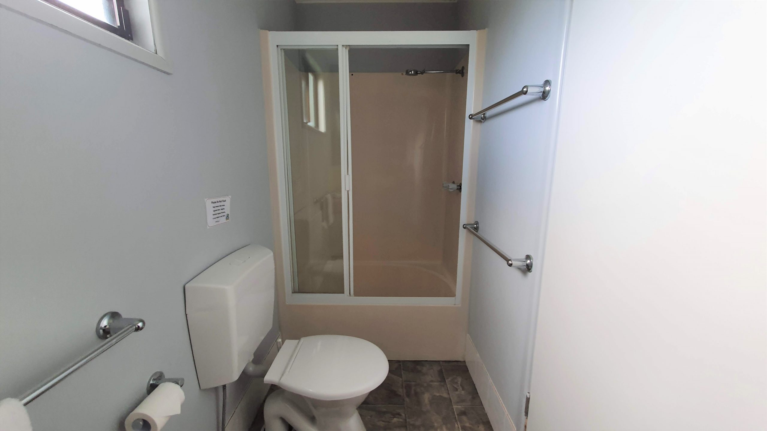 Shower and toilet in the bathroom of a Double Cabin at Alex Beach Cabins